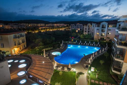 a view of a swimming pool in a city at night at Hotel Miramar Sozopol in Sozopol