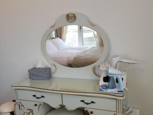 a dressing table with a mirror on top of it at HANI Haus in Jeju