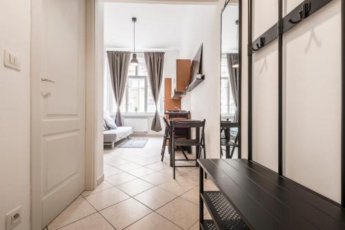 a living room with a table and a dining room at Tyrsova Apartment in Prague