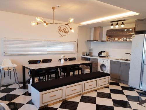a kitchen with a table and chairs in a kitchen at HANI Haus in Jeju
