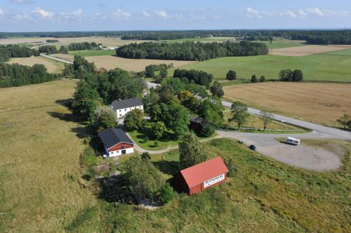 an aerial view of a farm with a barn and a road at Tössestugan in Tösse