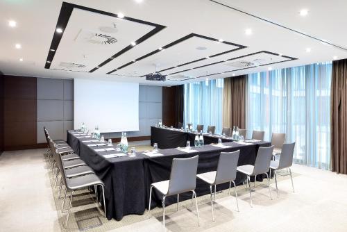 a conference room with a long table and chairs at Eurostars Berlin in Berlin