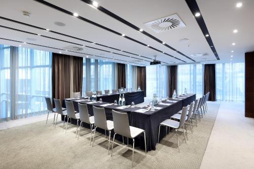 a conference room with a long table and chairs at Eurostars Berlin in Berlin