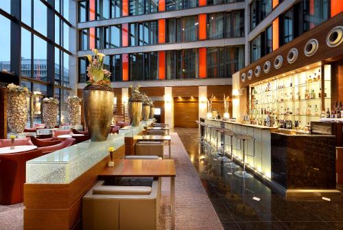 a restaurant with a bar in a building at Eurostars Berlin in Berlin
