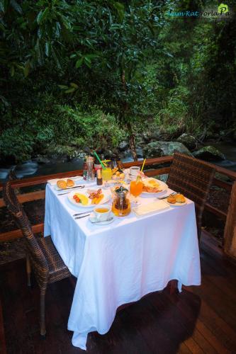 a white table with food and drinks on it at Namkat Yorla Pa Resort in Ban Kat