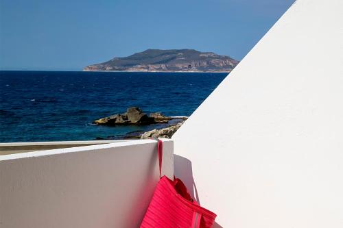 a view out the window of the ocean from the balcony of a boat at Residence Scirocco e Tramontana in Favignana