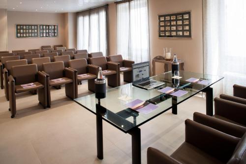 a conference room with a glass table and chairs at Hotel Dei Fiori Restaurant - Meeting & Spa in Alassio