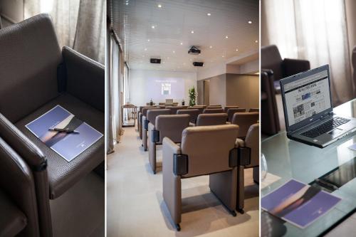 a conference room with a laptop computer on a table at Hotel Dei Fiori Restaurant - Meeting & Spa in Alassio