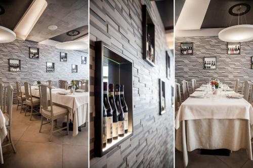 a dining room with a table with wine bottles at Hotel Dei Fiori Restaurant - Meeting & Spa in Alassio