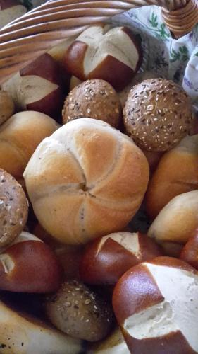a basket full of bagels and fruits and vegetables at Haus Odo in Lech am Arlberg