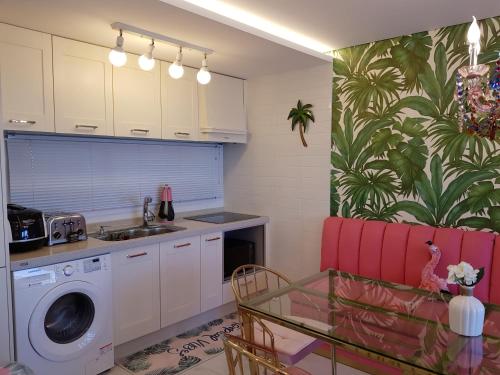 a kitchen with a sink and a washing machine at HANI Haus in Jeju