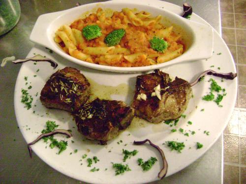 a plate of food with a bowl of pasta and meat at Lakelawn B&B and Motel in Yarmouth