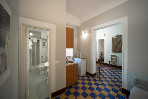 a bathroom with a toilet and a sink at Ai Lumi in Trapani