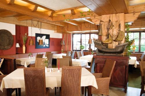 a restaurant with tables and chairs in a room at Gasthof Fischerstüberl in Rottau