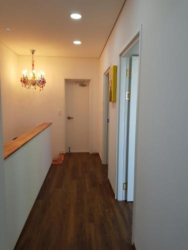 a hallway of an office with a chandelier at HANI Haus in Jeju
