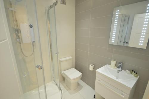 a bathroom with a shower and a toilet and a sink at 3A Soho Studios 3rd floor by Indigo Flats in London