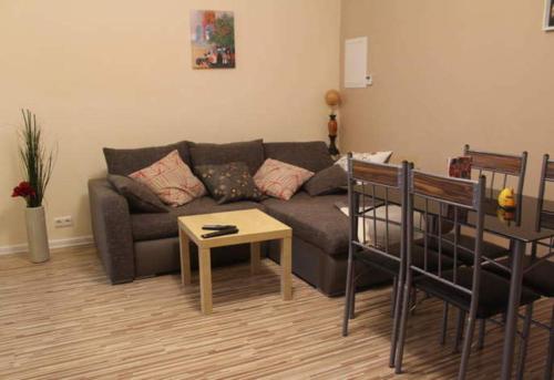 a living room with a couch and a table at Ferienhaus Mockritz in Dresden