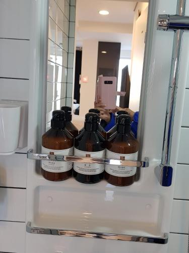 a refrigerator with four bottles of liquid in it at HANI Haus in Jeju
