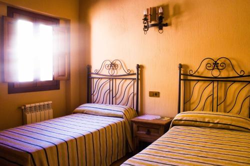 Postel nebo postele na pokoji v ubytování Hostal Restaurante Sierra De La Martina