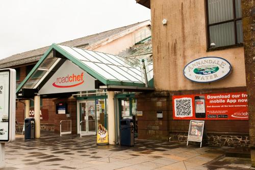 a building with a sign on the side of it at Days Inn Lockerbie - Annandale Water in Johnstonebridge