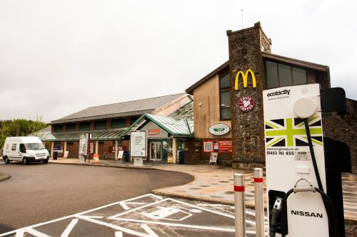 a building with a mcdonalds sign next to a street at Days Inn Lockerbie - Annandale Water in Johnstonebridge