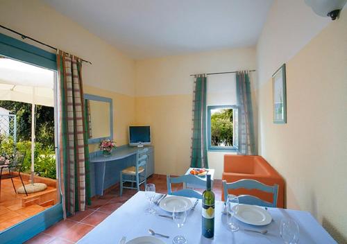 a dining room with a table with wine glasses on it at Valamar Tamaris Resort in Tar