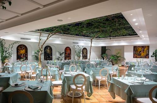a banquet hall with blue tables and chairs at Villa Romana Hotel & Spa in Minori