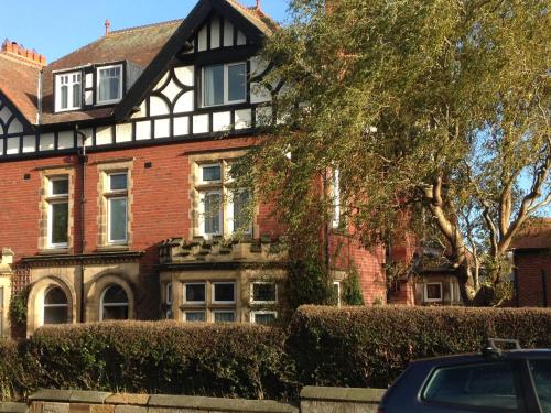 an old house with a car parked in front of it at Rivington House Room only in Whitby