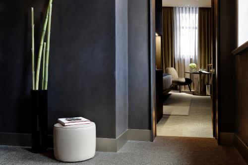 a hallway of a hotel room with a stool in the floor at ME Milan Il Duca in Milan