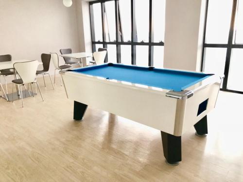 a pool table in a room with chairs at CoZy Suite @ PJ & Sunway(2 Bedroom) in Petaling Jaya