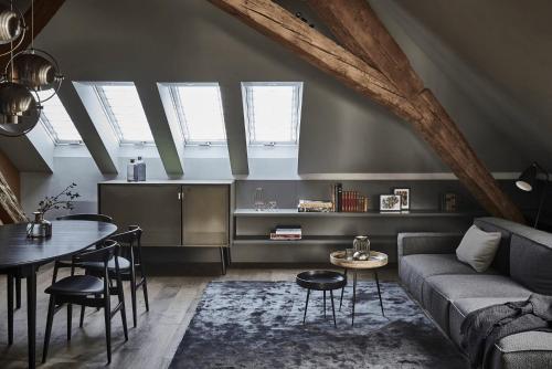 a living room with a couch and a table at Hotel Liberty Offenburg in Offenburg