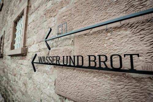 a sign on the side of a brick building at Hotel Liberty Offenburg in Offenburg
