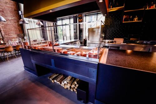 a kitchen with a counter in a restaurant at Hotel Liberty Offenburg in Offenburg