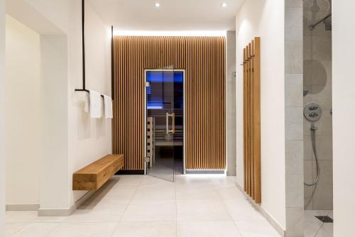 a bathroom with a walk in shower and a door at Bauer Hotel und Restaurant in Feldkirchen