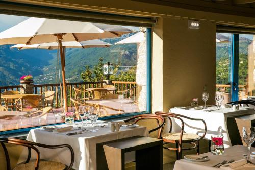 a restaurant with tables and chairs and a large window at Pousada Geres-Caniçada in Geres
