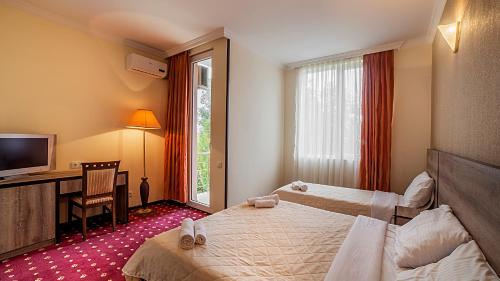 Postel nebo postele na pokoji v ubytování Orange Hotel