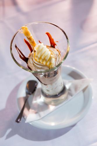 a dessert in a glass sitting on a plate at Hari Club Beach Resort in Aghīr