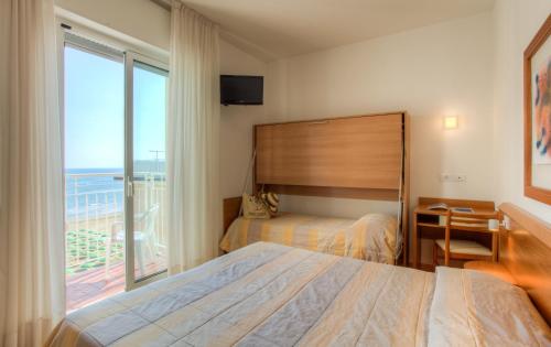 Postel nebo postele na pokoji v ubytování Hotel Ancora