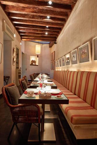 una lunga sala da pranzo con un lungo tavolo di Hotel Boutique Corral del Rey a Siviglia