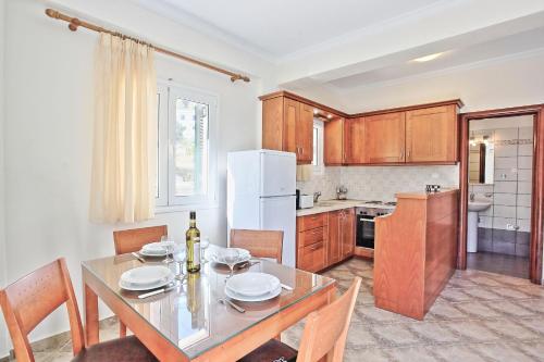 a kitchen with a dining table and a refrigerator at Katerina House in Kalami
