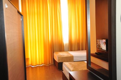 a small room with two beds and a mirror at Luxor Complex in Ivaylovgrad