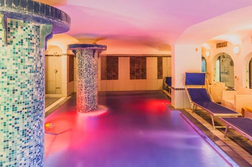 a pool in a building with a water fountain at Aragona Palace Hotel & Spa in Ischia