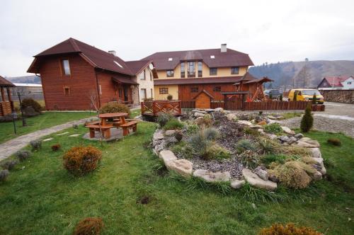 a large house with a garden in front of it at Panorama Yasinya in Yasinya
