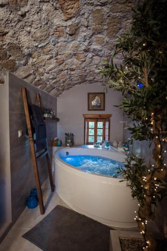 a bath tub in a bathroom with a stone ceiling at CASA FELICIA-The Castle Mansion in Monemvasia