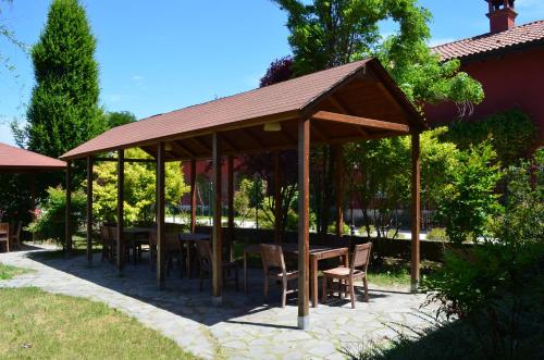 a gazebo with tables and chairs under it at Agriturismo Cascina Maiocca in Mediglia