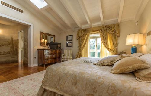 a bedroom with a large bed and a window at Villa Rinaldi in Montespertoli