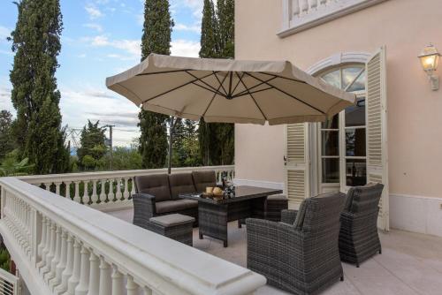 a patio with a table and chairs and an umbrella at Villa Rinaldi in Montespertoli