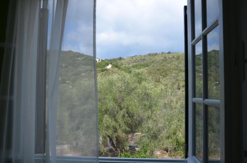 an open window with a view of a mountain at Villa Clementine in Gaios