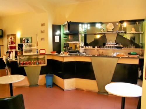 a kitchen with a counter and tables in a restaurant at Hotel Minerva in Milan