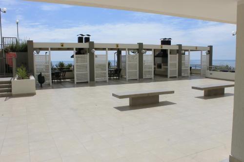 a pavilion with benches on top of a building at Apartamento Altos de Huayquique in Iquique